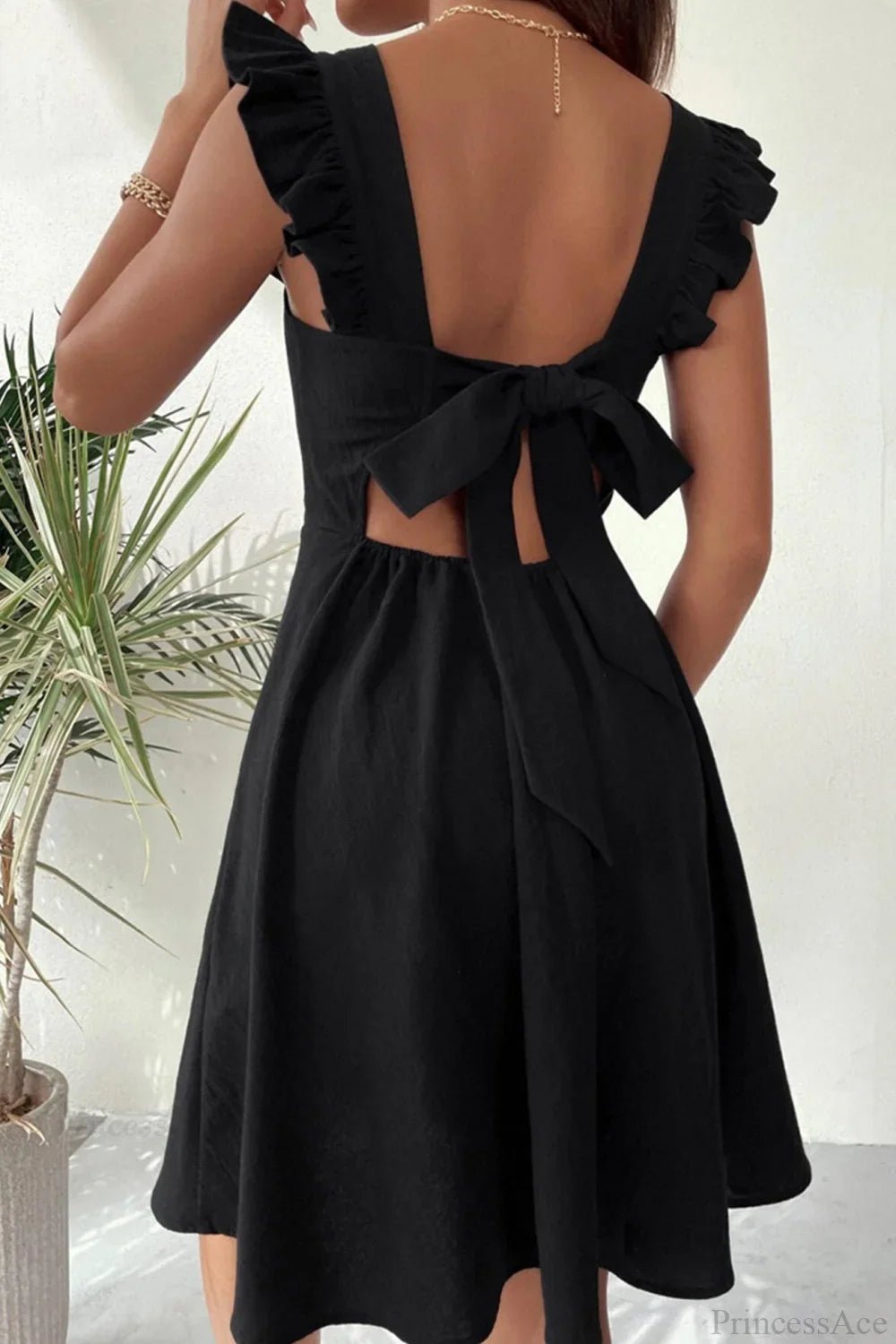 Carmen mini robe sans manches avec nœud volanté au dos