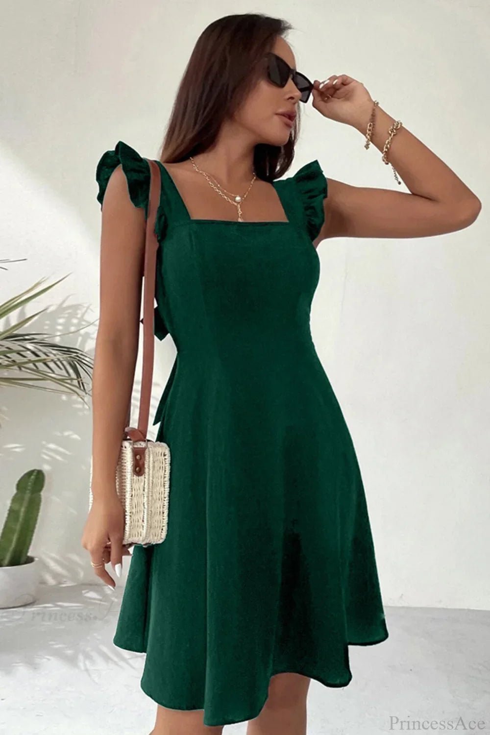 Carmen mini robe sans manches avec nœud volanté au dos